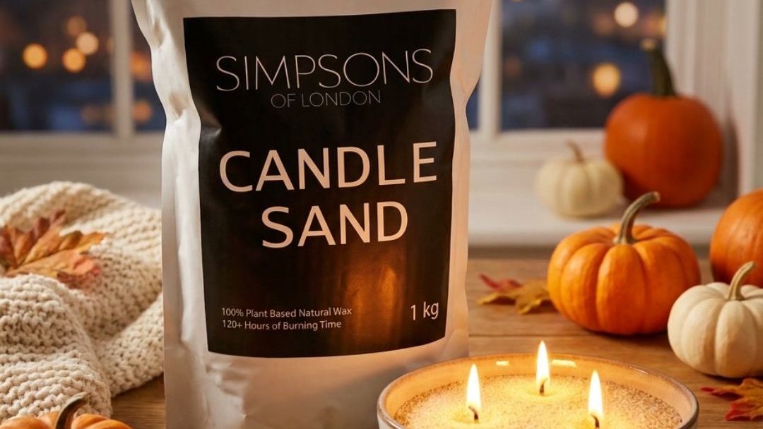Simpsons of London candle sand pouch beside a lit bowl of candle sand on a dusk windowsill